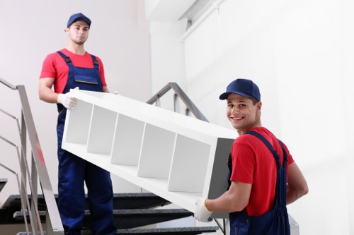 Moving team loading household items into a removal vehicle