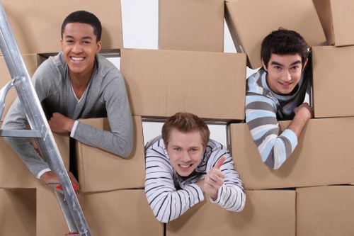 Professional movers handling furniture in a Clapham property with stairs