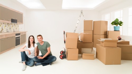 Local packing team handling furniture and boxes in a Clapham flat with narrow access