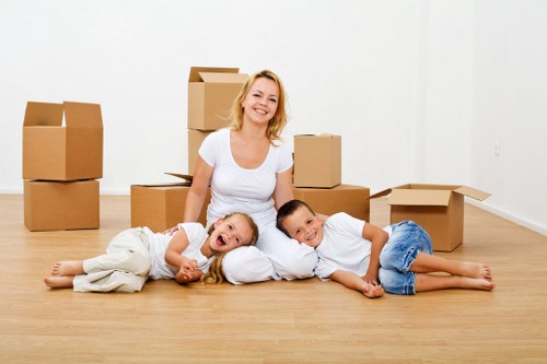 Removalists carrying furniture through a Clapham residential street