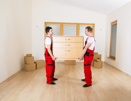 Removal crew navigating stairs and access challenges in Clapham flats